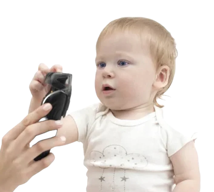 Toddler holding clippers – the Little Legends first haircut experience at Uppercuts