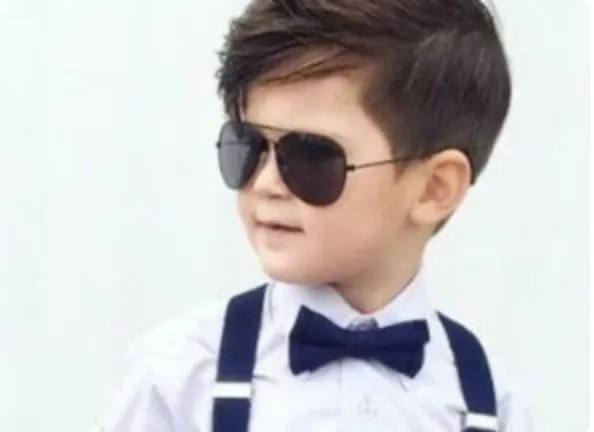 Kid with a fresh haircut and sunglasses