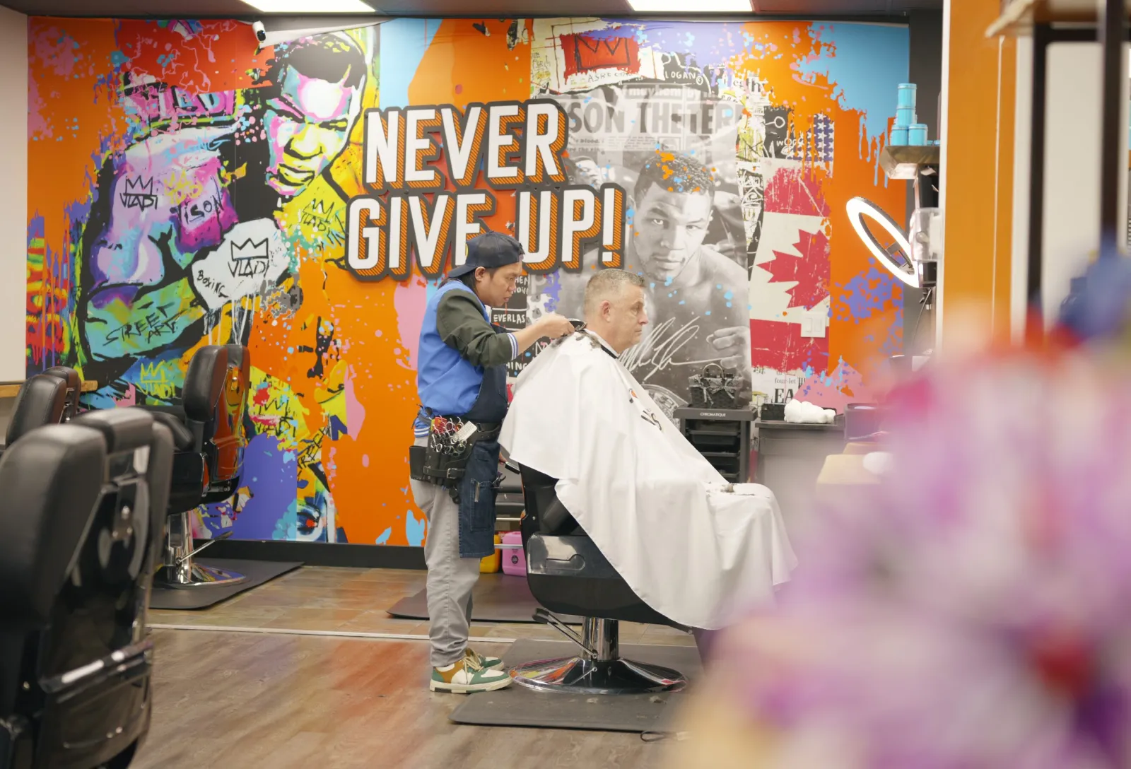 Barber chairs in front of the Mike Tyson mural at Uppercuts Barbershop Walnut Grove, Langley