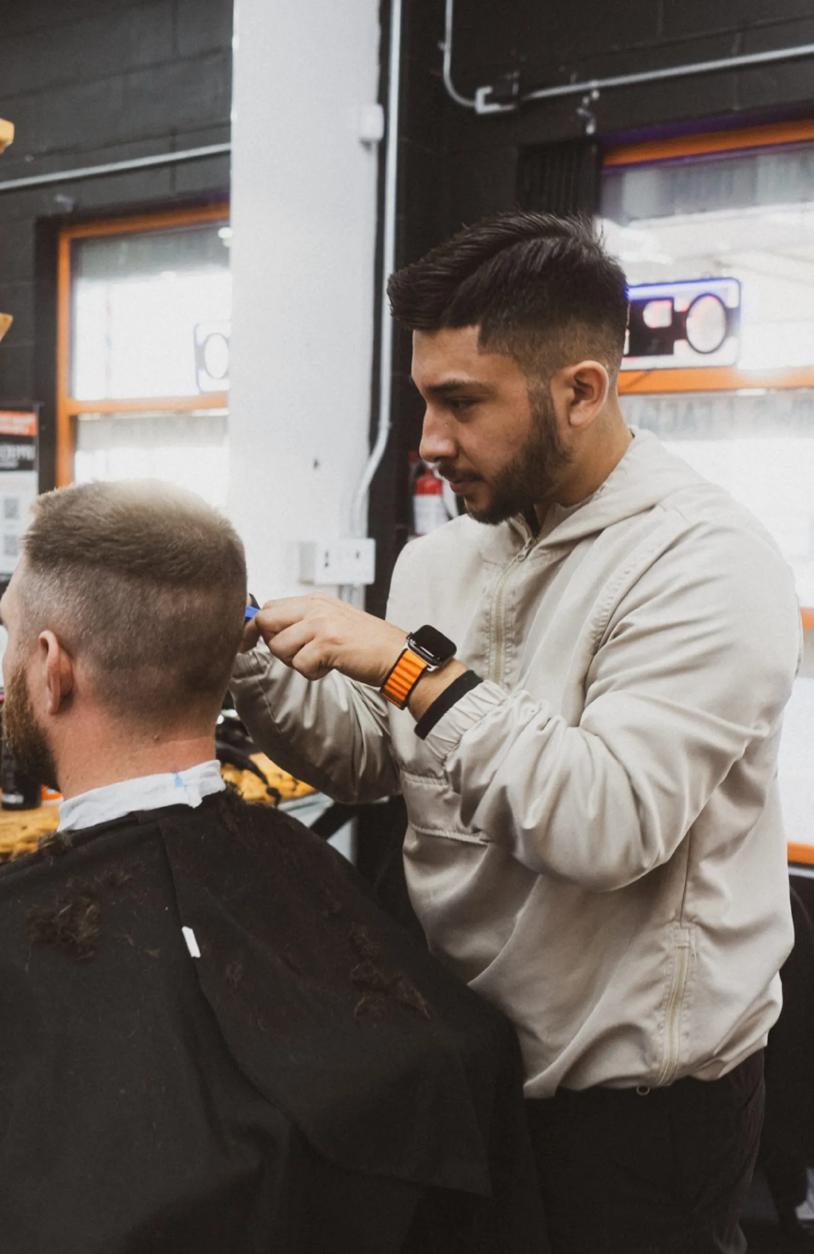 Uppercuts barber working on a fade