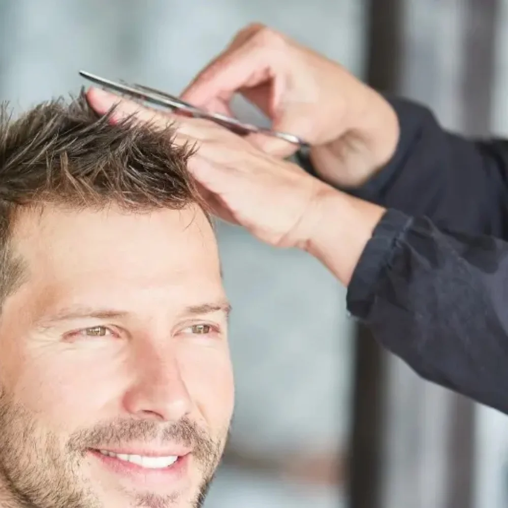 Barber consulting with a client before a scissor cut