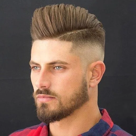 Adult skin fade with a textured top at Uppercuts Barbershop